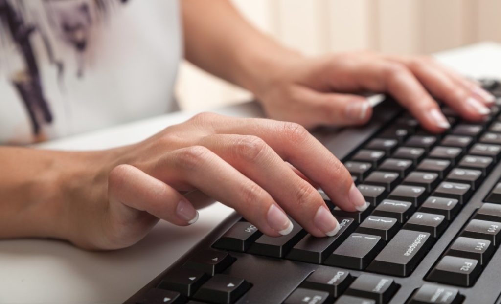 Woman Typing at a Keyboard